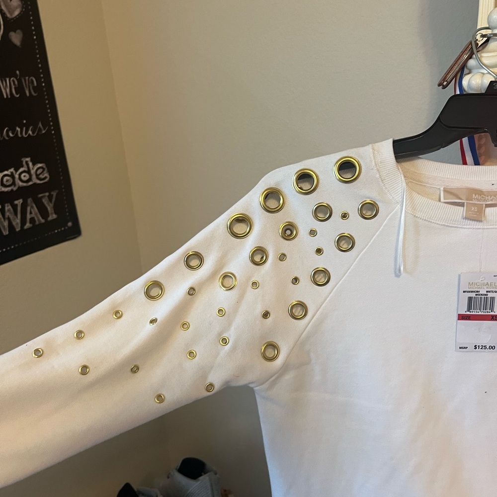 White Michael Kors top with flattering gold openings along shoulder